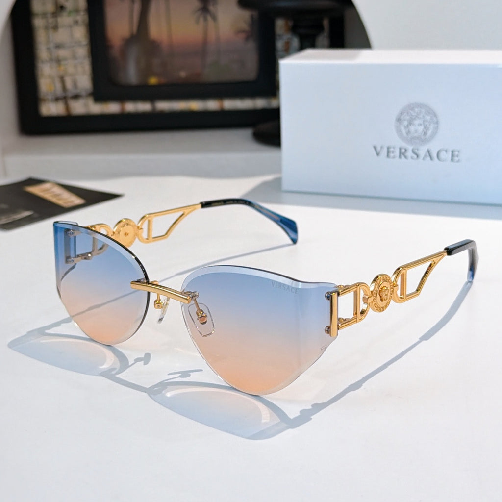 Gold-frame cat-eye sunglasses with blue-tinted mirrored lenses.