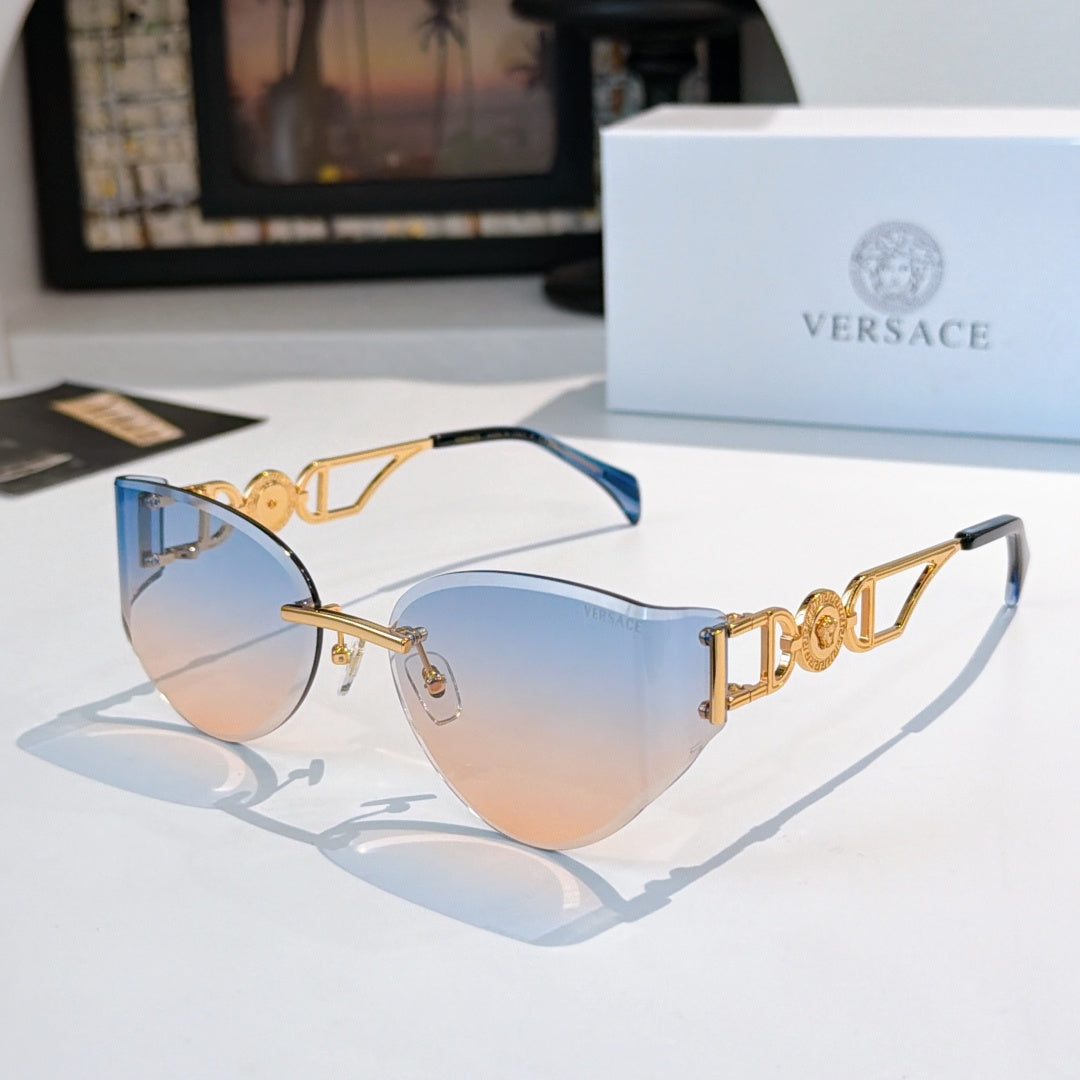 Gold-frame cat-eye sunglasses with blue-tinted mirrored lenses.