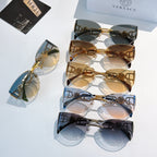 Stack of gold-frame cat-eye sunglasses with mixed tinted mirrored lenses.