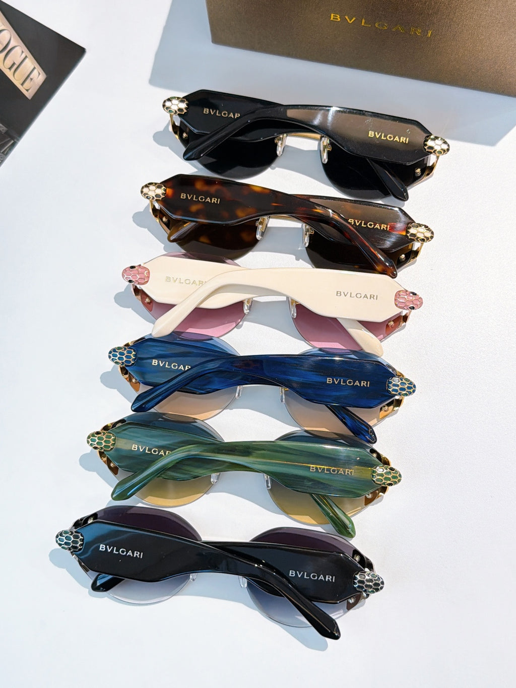Bvlgari sunglasses set with multiple frame colors, stacked view showing lens tints and gold details