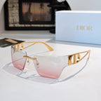 Sunglasses with pink-to-clear gradient lenses and gold-tone frame, shield shape