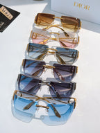 Stack of sunglasses with gold-tone frames and multicolor gradient lenses