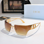 Sunglasses with amber gradient lenses and gold-tone frame, shield shape