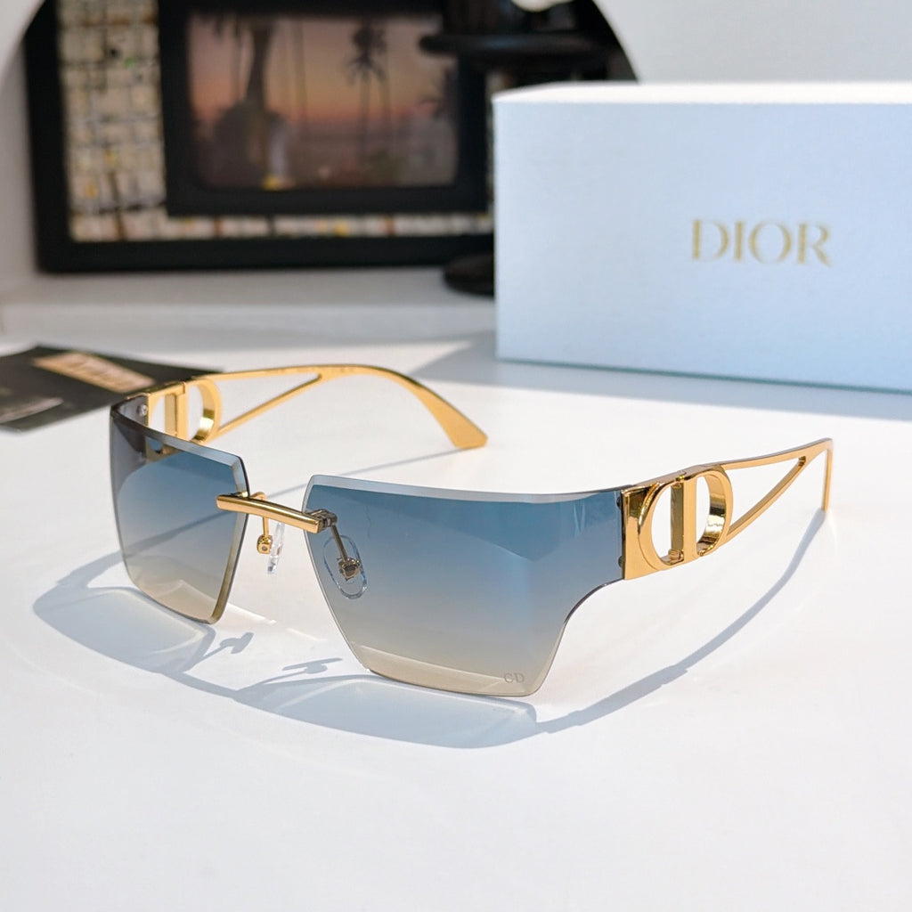 Sunglasses with light blue gradient lenses and gold-tone frame, shield shape