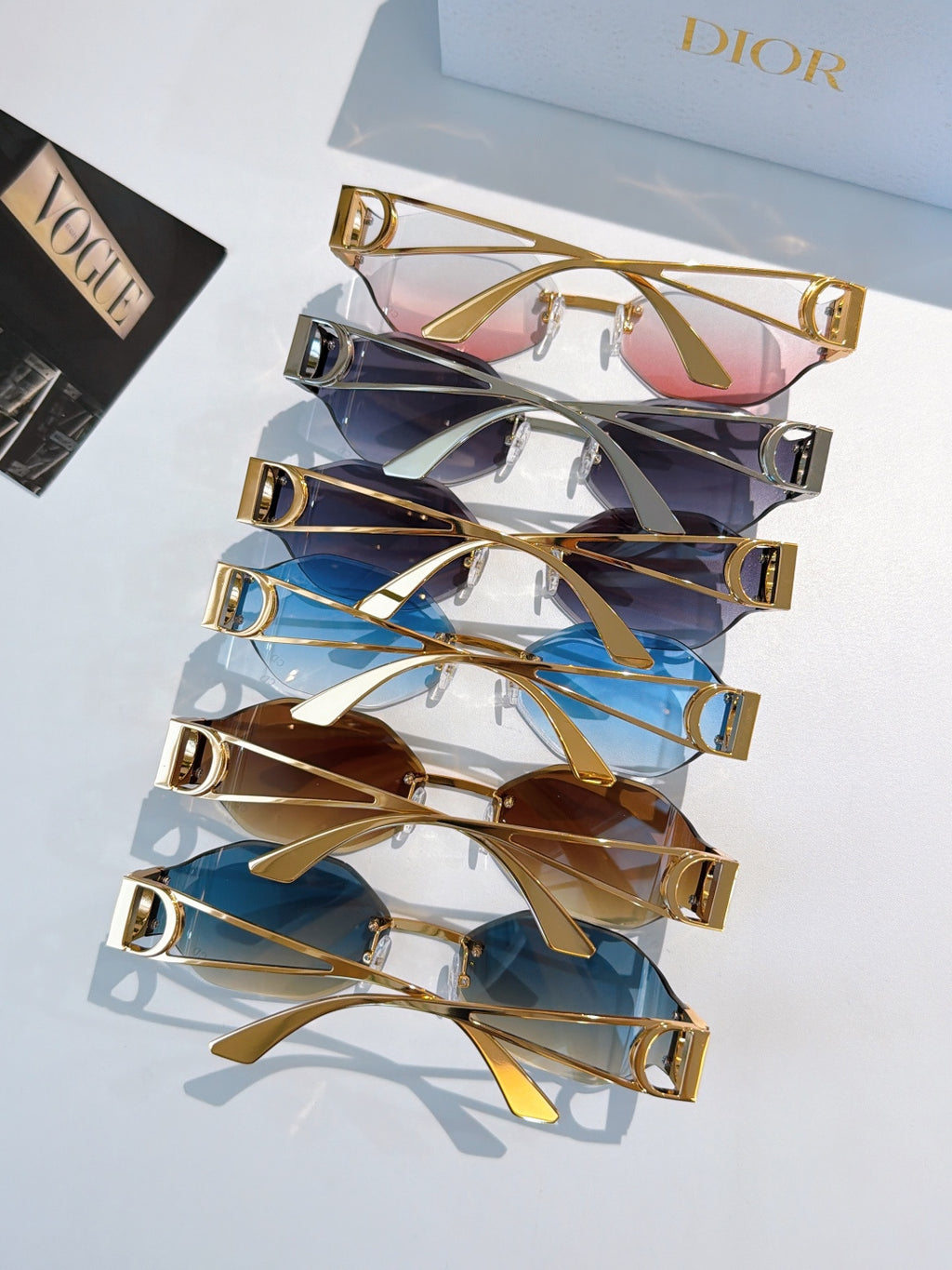 Dior sunglasses display set with assorted tinted lenses and gold-tone frames