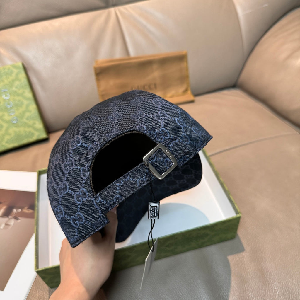 Gucci navy GG monogram cap with front strap and metal buckle, underside view