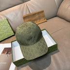 Gucci logo baseball cap in dark green with allover GG pattern, curved brim