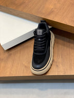Black sneakers with beige edge stripe and Greek logo on tongue