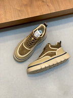 Luxury sneakers pair, olive suede with beige accents, lace-up and chunky base