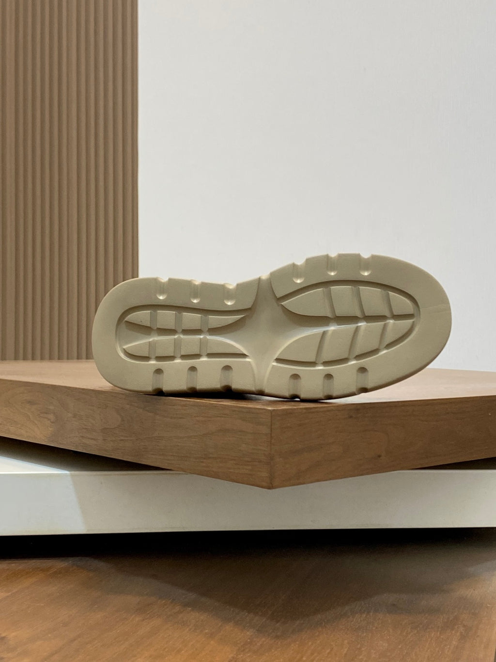 Luxury sneaker rubber outsole, light beige tread pattern on chunky sole
