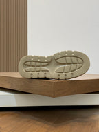 Luxury sneaker rubber outsole, light beige tread pattern on chunky sole