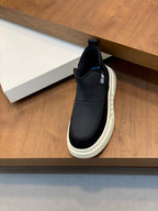 Givenchy dark slip-on sneakers on shelf with white midsole detail