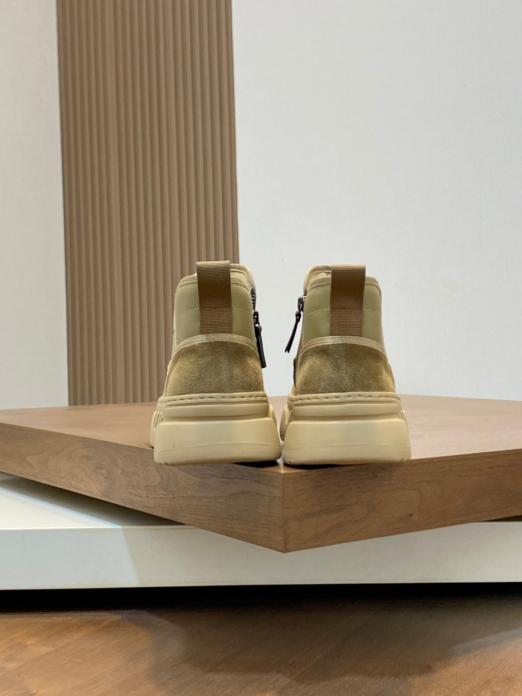 Beige Givenchy high-top sneakers viewed from behind on a display shelf