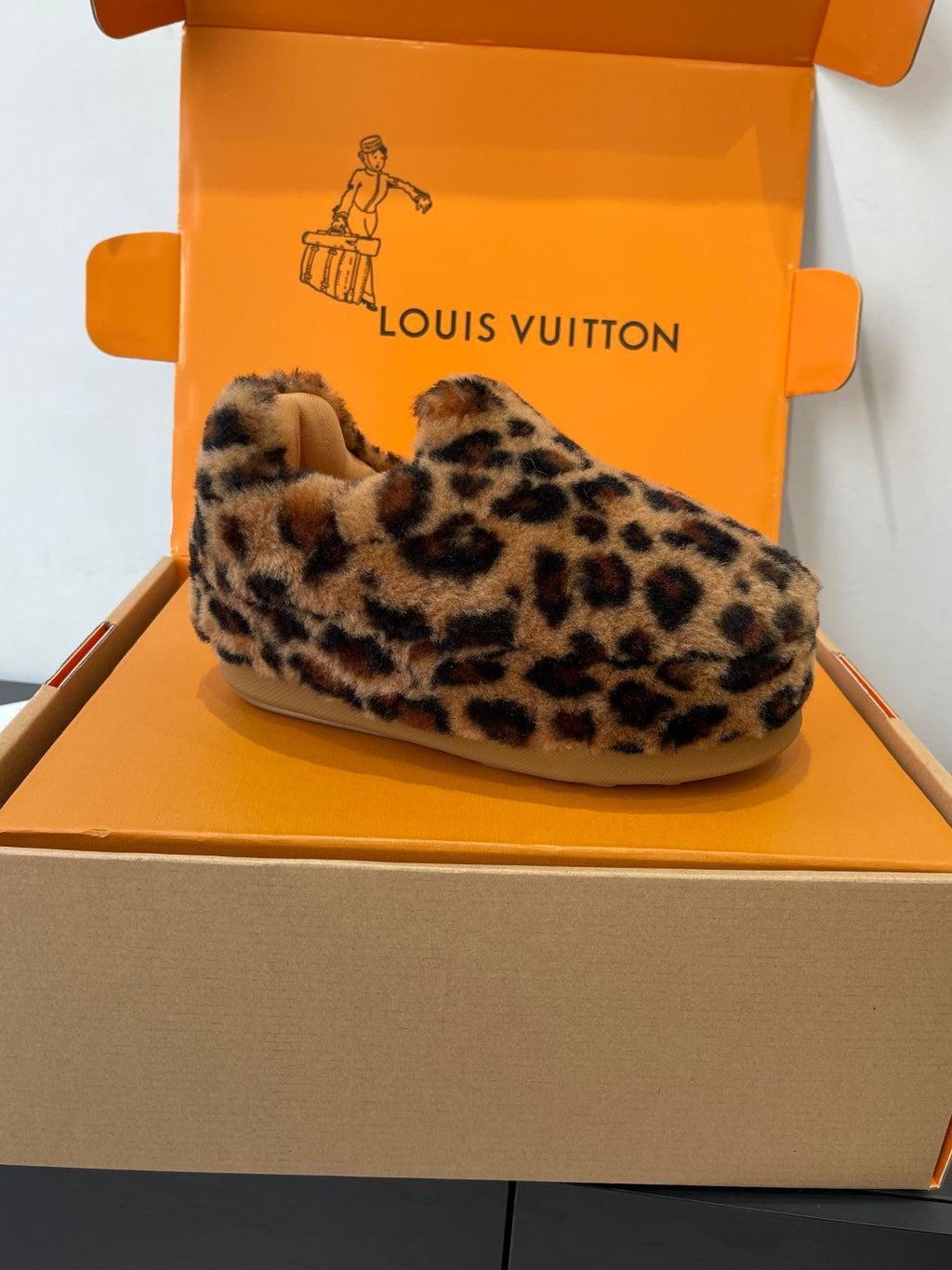 Leopard-print faux-fur slip-on shoe on display, beige sole