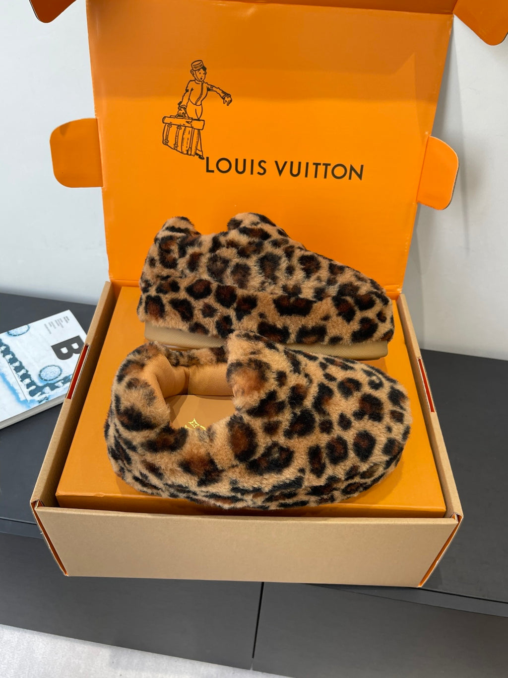 Pair of leopard-print faux-fur slip-on shoes with beige soles