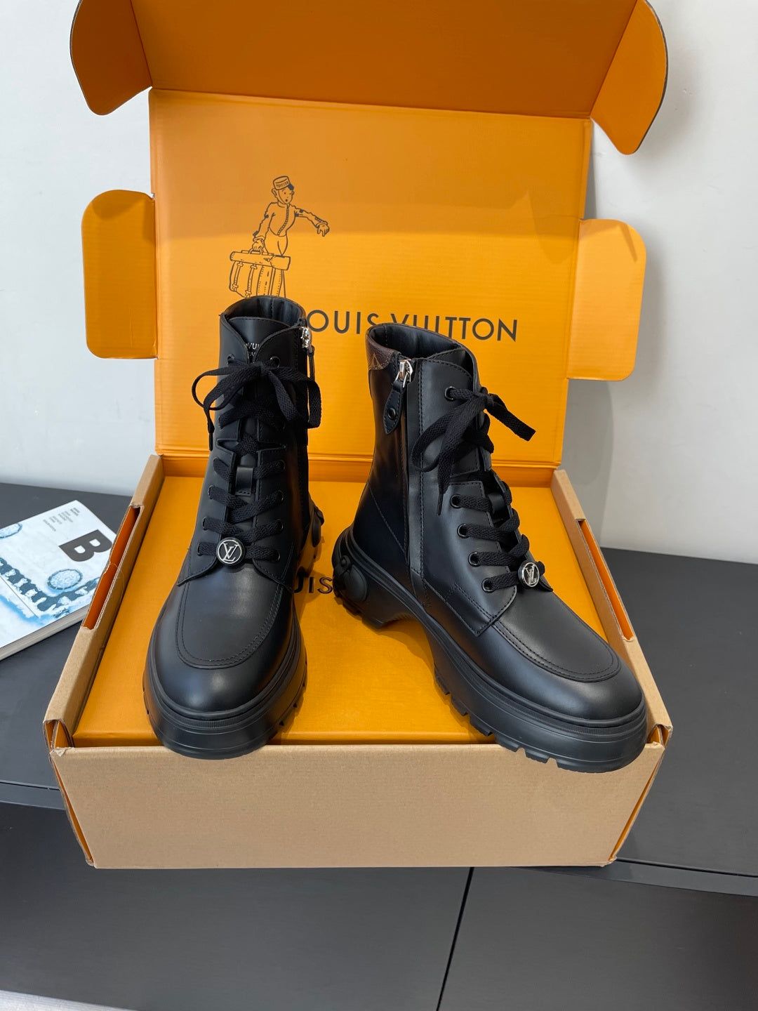 Louis Vuitton unisex black leather lace-up ankle boots, front view with chunky sole