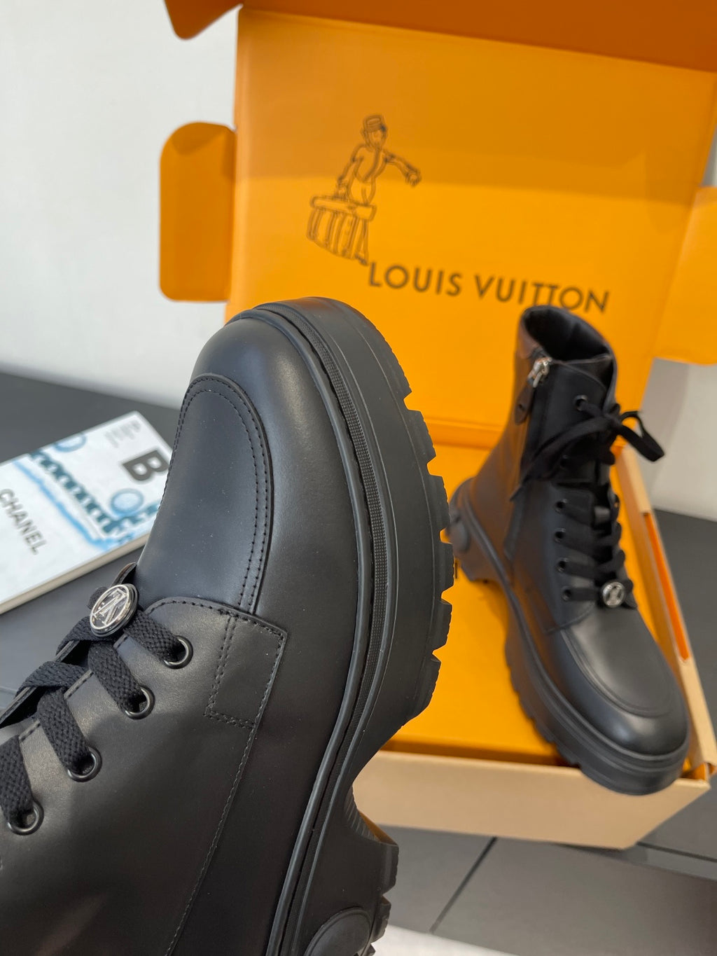 Louis Vuitton unisex black leather lace-up ankle boot, side profile and stitched panels