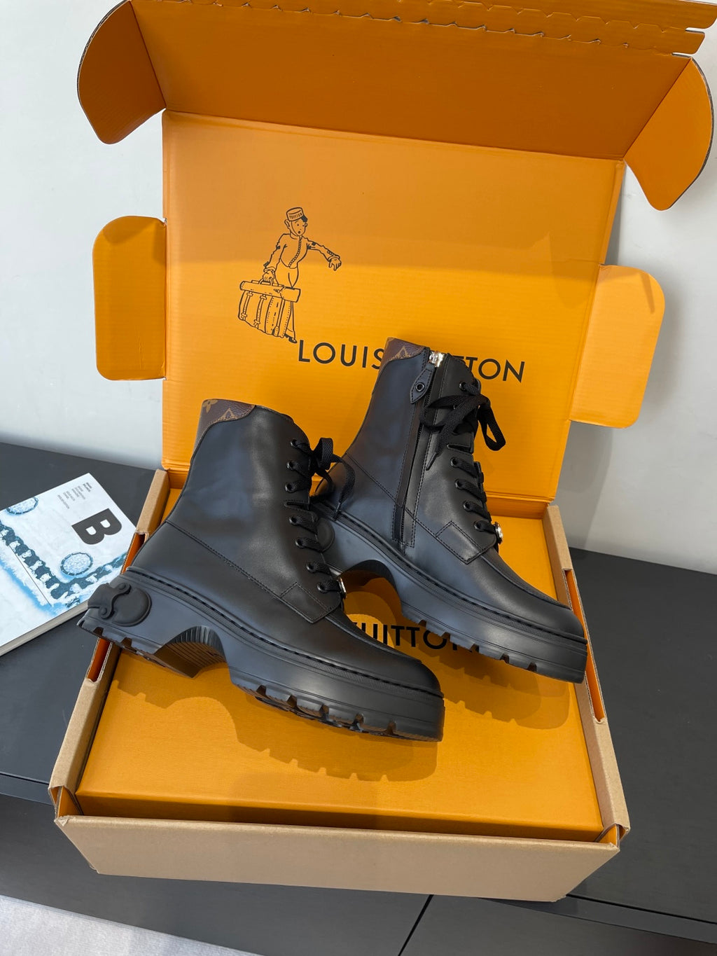 Louis Vuitton unisex black leather lace-up ankle boots with thick outsole and pull tab