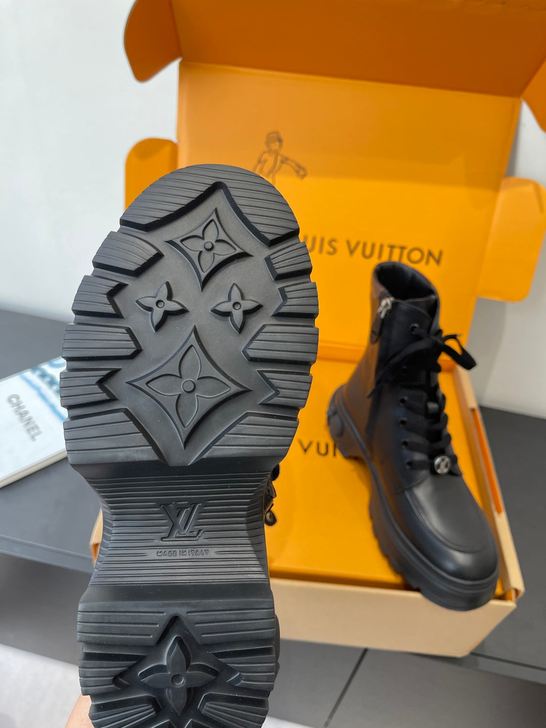 Louis Vuitton unisex boot outsole with geometric tread, paired with black lace-up boot