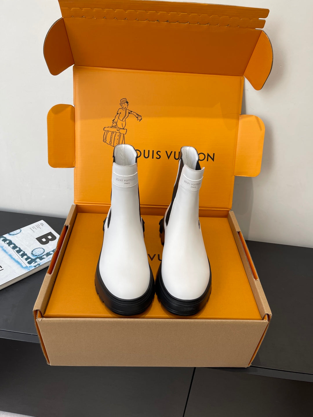 Louis Vuitton chelsea boots in white with black elastic side panels and chunky lug soles