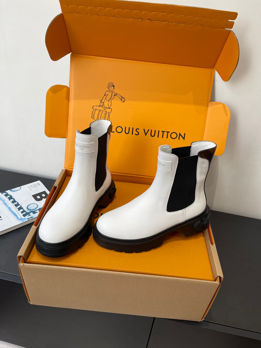 Louis Vuitton white chelsea boots with black elastic sides and thick black lug soles