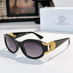 Round sunglasses with black frame, gold-tone arms, and purple tinted lenses