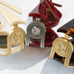 Close-up of sunglasses frames with gold medallion hinges in cream, red, and dark tortoise