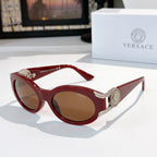 Cat-eye sunglasses with red frame, silver-tone hinges, gold-tone arms, and brown tinted lenses