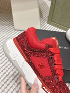Close-up of red glitter lace-up sneakers with textured upper and white sole