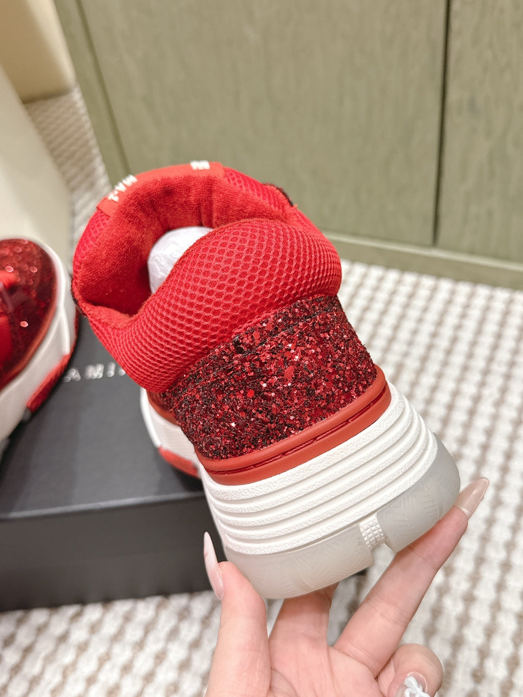 Heel view of red glitter sneakers with textured upper and white sole