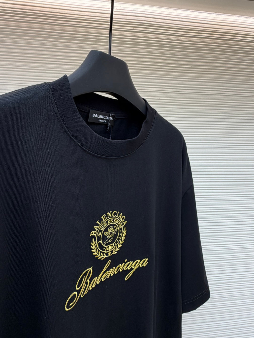 Dark short-sleeve T-shirt with gold Balenciaga crest and signature script