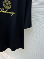 Dark short-sleeve T-shirt with gold Balenciaga script and curved hem