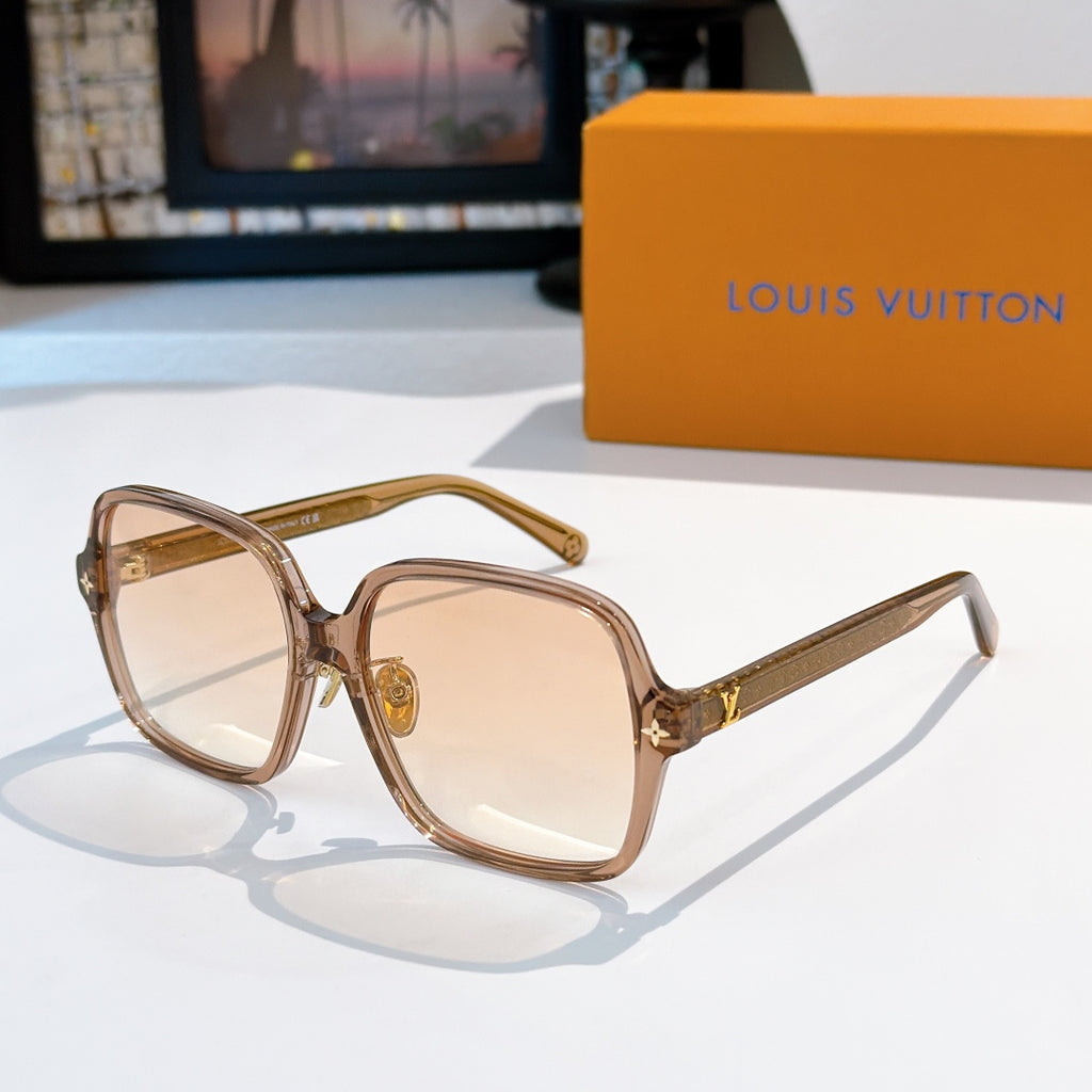 Brown-tinted sunglasses with gold temple detailing and beige lenses