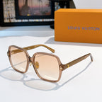 Brown-tinted sunglasses with gold temple detailing and beige lenses