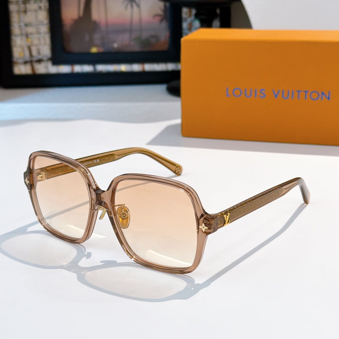 Brown-tinted sunglasses with gold temple detailing and beige lenses
