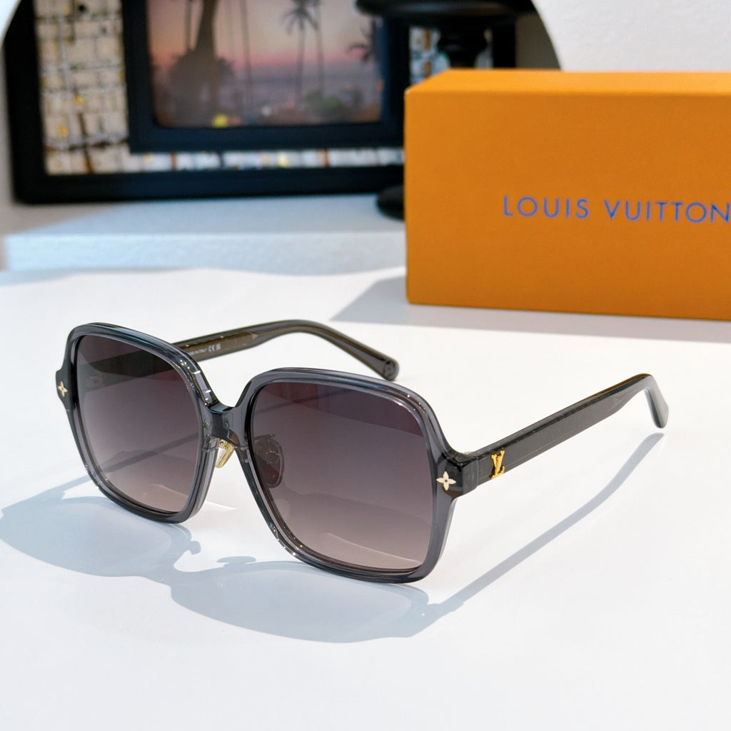 Black square sunglasses with dark lenses and gold accent detail at temples