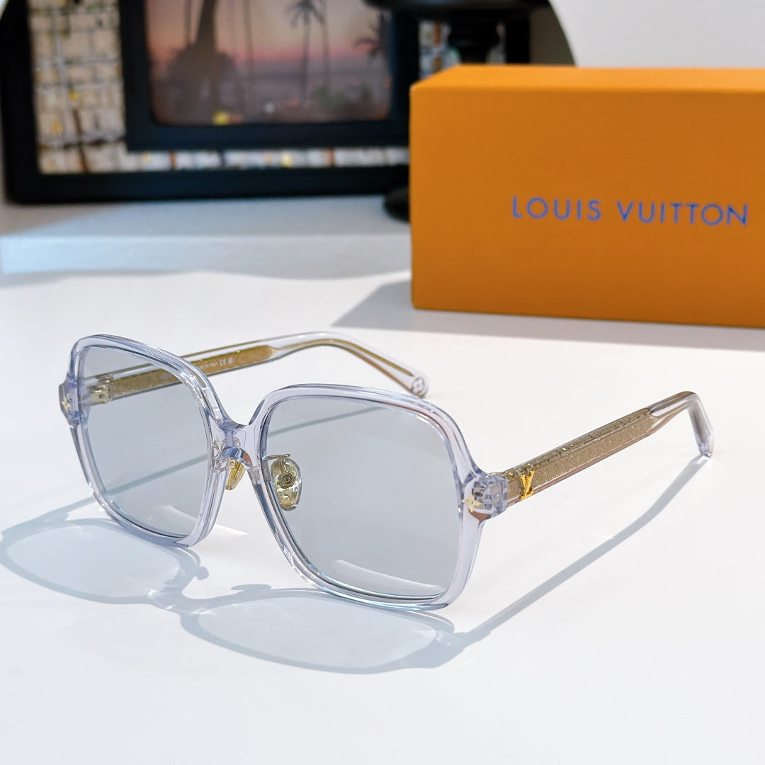 Translucent blue sunglasses with gold temple detailing and light lenses
