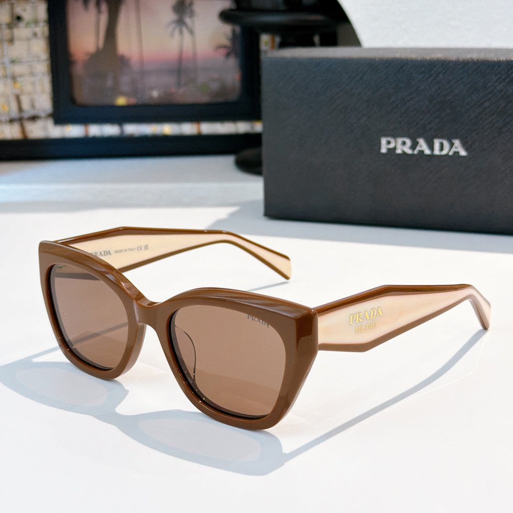 Prada sunglasses with tan frames and brown tinted lenses, oversized round cat-eye style