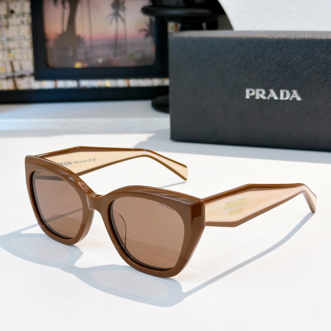 Prada sunglasses with tan frames and brown tinted lenses, oversized round cat-eye style