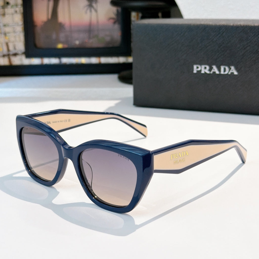 Prada sunglasses with dark blue frames and tinted purple lenses, round cat-eye shape