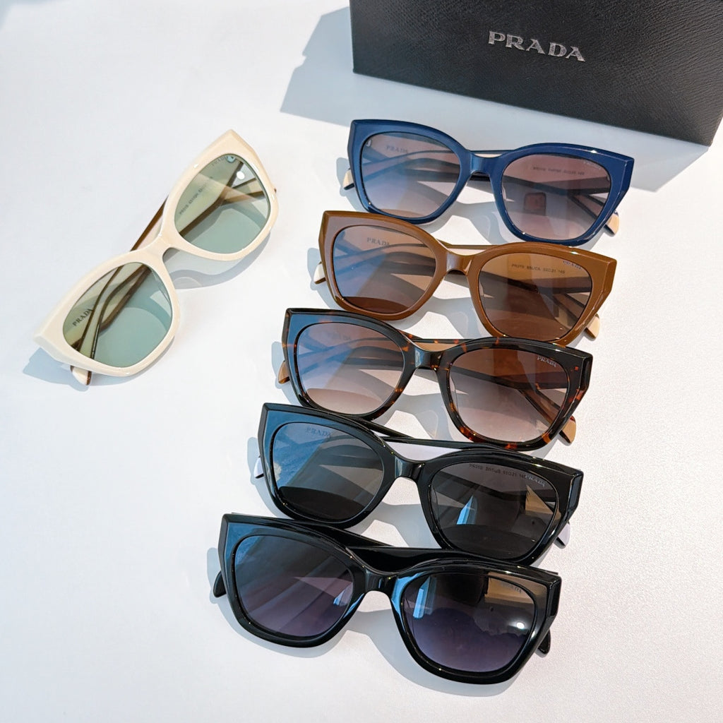 Prada sunglasses set with multiple frames and tinted lenses, blue, tan, and black pairs