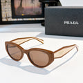 Prada cat-eye sunglasses with brown gradient lenses and tortoise frame.