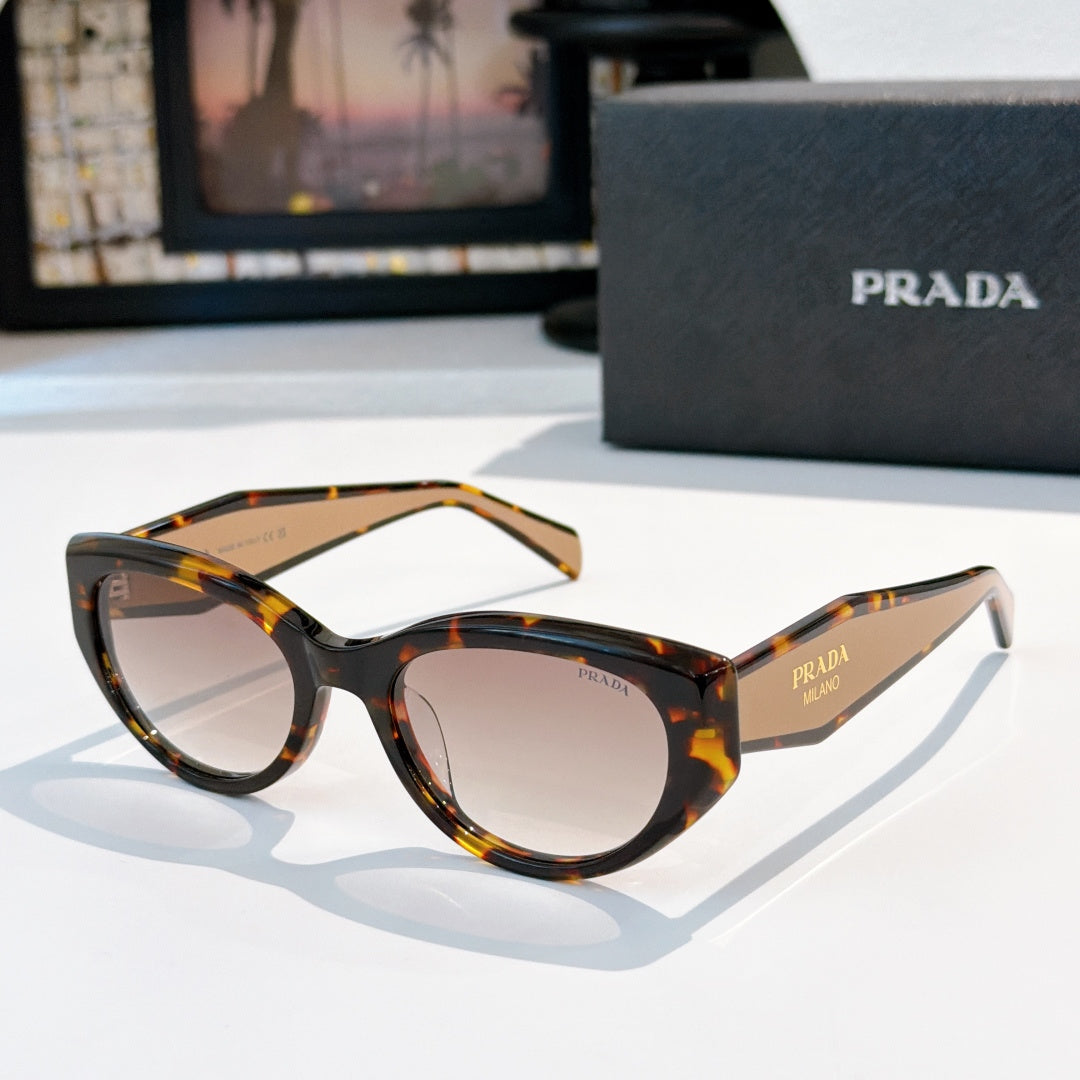 Prada cat-eye sunglasses with tortoise frame and dark tinted lenses.