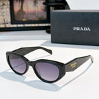 Prada cat-eye sunglasses with dark frame and deep tinted lenses.