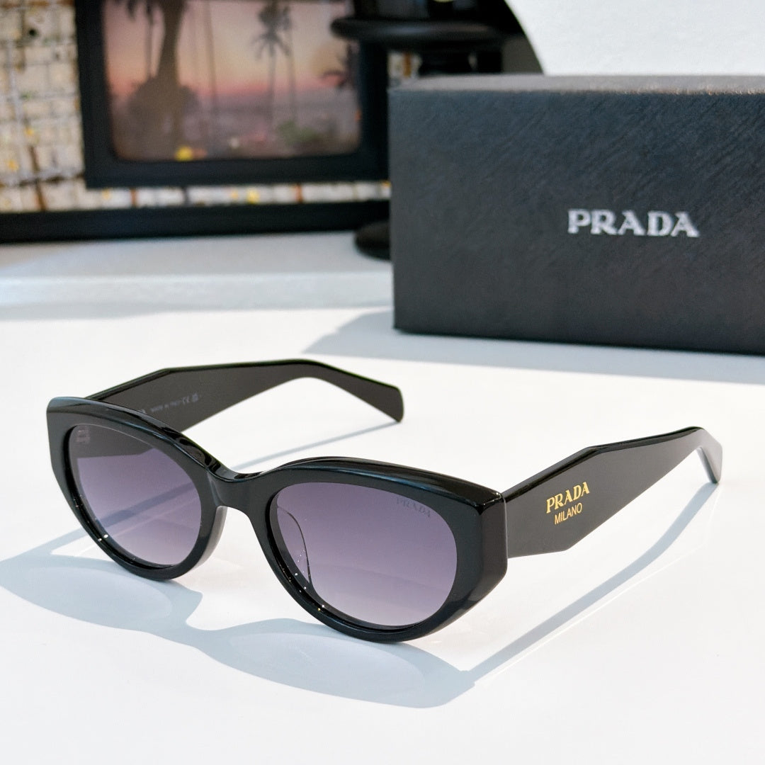 Prada cat-eye sunglasses with dark frame and deep tinted lenses.
