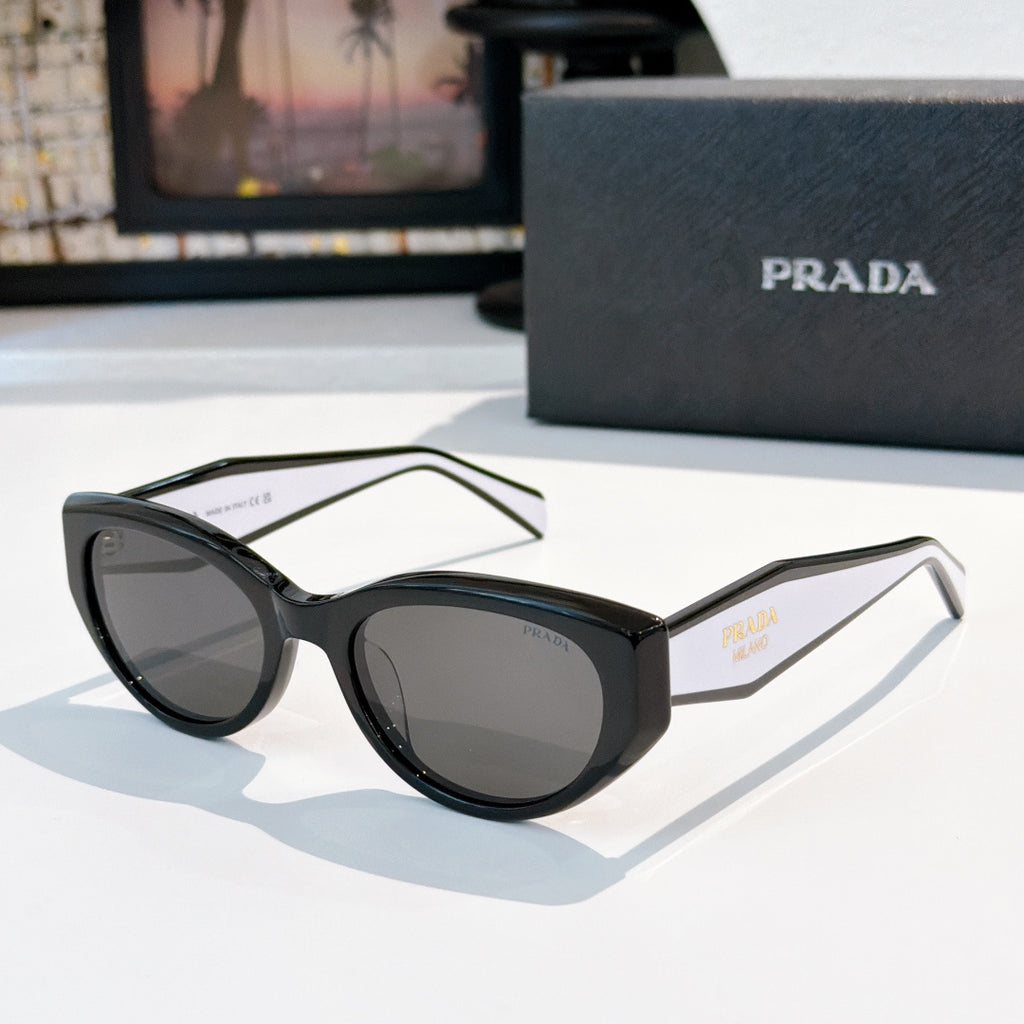 Prada cat-eye sunglasses with black frame and dark tinted lenses.