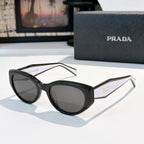 Prada cat-eye sunglasses with black frame and dark tinted lenses.