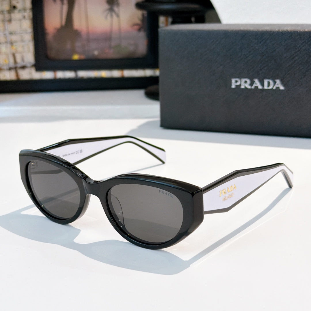 Prada cat-eye sunglasses with black frame and dark tinted lenses.