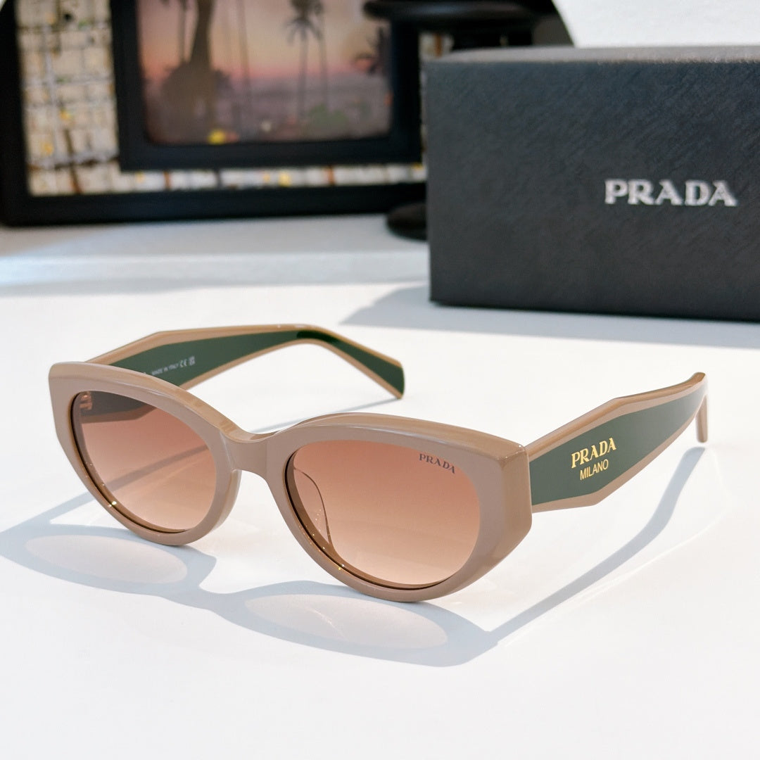 Prada cat-eye sunglasses with cream frame and rose-tinted lenses.