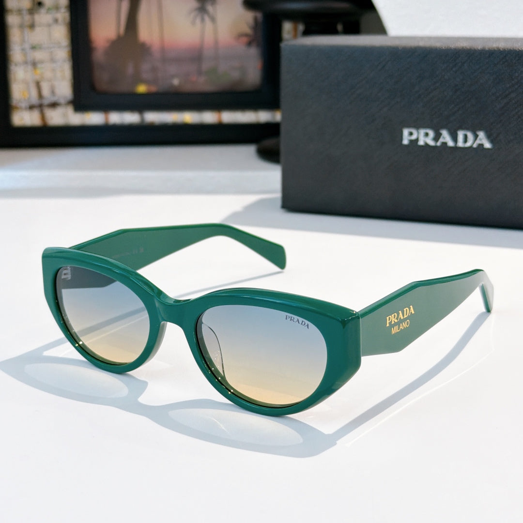 Prada cat-eye sunglasses with green frame and reflective tinted lenses.